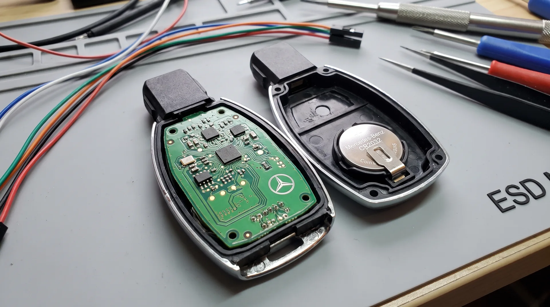 Open Mercedes-Benz key fob showing the coin battery inside